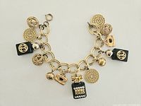 Full overview of the vintage charm bracelet showing all charms, chain links and clasp.