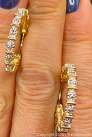Close-up front view showing diamond bezels and gold finish