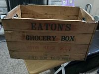 Front and side view showing branding and fold instructions on the wooden box.