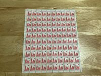 Front side view of the full sheet of 100 Canadian 14 cent stamps, showing the red design with Parliament buildings image.