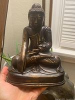 Front view of seated Buddha statue showing posture and overall appearance