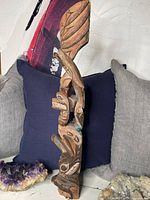 Front view of the totem pole displaying bird figure and detailed carvings.