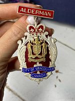 Front view of the sterling silver and enamel Alderman medal with city crest and enamel banners.