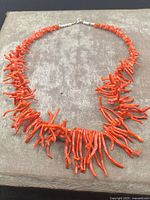 Full view of the Victorian genuine coral branch necklace laid flat showing vibrant red-orange coral branches and sterling silver clasp.