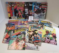 Overview of cushioned comics standing upright and lying down showing titles like The Weird, Blackhawk, and several Superman issues.