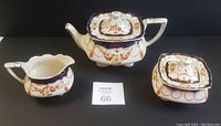 Full view of the MYOTT 'Rosemary' china set showing teapot, creamer, and sugar bowl on black background