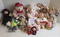 Group photo of all stuffed animals in lot including bears, lamb, bunnies, and other small plush animals.