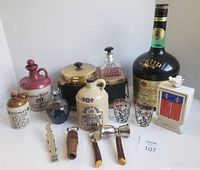 Overview of all vintage barware items including decanter, ice buckets, various bottles and accessories.