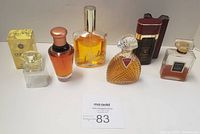 Six assorted women's fragrances displayed in a row, including boxed Versace Yellow Diamond and other bottles.