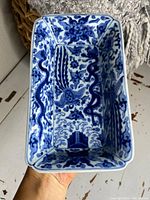 Interior view showing underglaze cobalt blue dragon and phoenix motifs against white ground