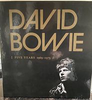 Black slipcase box cover with gold lettering and David Bowie portrait