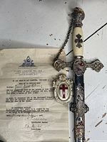 Close view of sword hilt and Tyee Lodge No. 66 certificate with printed header and signatures