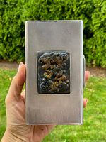 Full view showing silver case with jade box on top