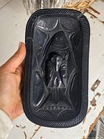 Front top view of bowl held in hand showing overall shape, design and scale