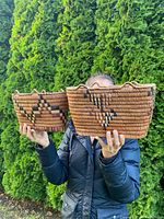 Front view of both baskets held by model to show scale