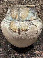 Front view of the Robin Hopper pottery vase showing floral glaze design and textured surface.