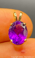 Close-up of the faceted oval amethyst set in 14k gold prong setting, highlighting color and setting details.