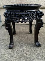 Front view of plant stand showing carved apron and cabriole legs