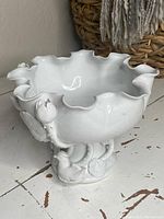 Side view showing scalloped rim, lotus buds, plastic birds and base design.