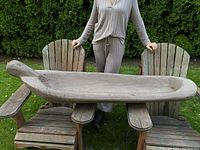 Side profile view of canoe placed across two outdoor chairs