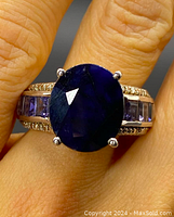 Top view showing oval blue sapphire center and surrounding amethyst and diamond accents