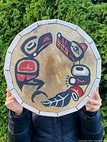Front view of round hide drum with hand-painted Northwest Coast Indigenous-style motif