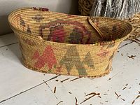 Front profile view showing oval shape and pictorial motifs in red, green and brown.