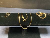 All three pieces displayed on black jewelry stand