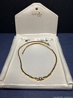 Necklace displayed inside white leatherette DePrisco box