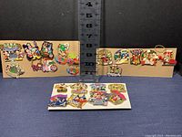 21 Disney holiday themed trading pins displayed on backing cards and loose showcasing various characters and events.