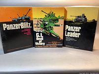 Front cover view of the three Avalon Hill board games Panzer Blitz, G.I. Anvil of Victory, and Panzer Leader with illustrated WWII tank and soldier artwork.