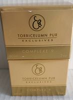 Photo of two boxed bottles of Elizabeth Grant Torricelumn Pur Complexe 9 skincare, showing front and packaging.
