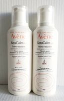 Front view of two white bottles of Avène XeraCalm A.D Lipid-Replenishing Balm showing brand and product details
