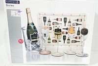 Box showing front view of Luminarc Bistro Collection 10-piece set with champagne bottle ice bucket, four decorated champagne flutes, four coasters, and table mat