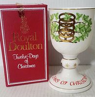 Photo of the goblet next to its original red box with gold and white 'Royal Doulton Twelve Days of Christmas' lettering.