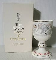 Photo of the Royal Doulton goblet alongside its original box, showing detailed swan artwork and series branding on the box.