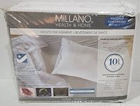 Front view of sealed original package for Millano Health & Home mattress encasement showing product name, silver clear treatment, and mattress/box spring fit details.