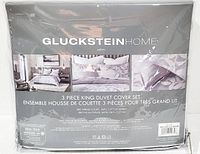 Packaging of GlucksteinHome Jardin 3 Piece King Duvet Cover Set showing product branding and images of the bedding set in a bedroom setting.