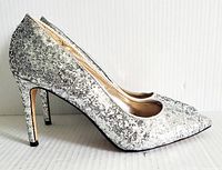 Side view of the silver glitter pointed-toe heels showing high heel and sparkle coverage.