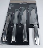 Full view of the Prime Chef 4-piece kitchen knife set in original packaging showing four knives with metal handles and protective sheaths.