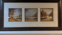 Full view of framed artwork showing three landscape prints within carved white mat and decorative brown frame.