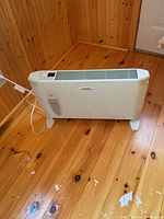 Full view of the Clairion convection heater on wooden floor showing overall condition and shape.