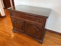 Photo of solid cherry Gibbard buffet showing the front with glass top, drawer, and paneled doors.