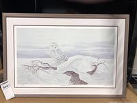 Framed print of snowy owl on snowy branch, showing entire artwork with frame