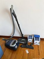 Full lot overview showing vacuum body, floorheads, hose, wand and bag boxes