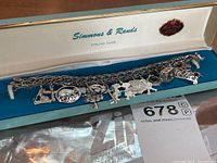 Sterling silver charm bracelet displayed in original Simmons & Rands box