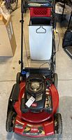 Front view of mower with grass collection bag attached
