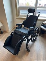 Front three-quarter view showing seat, back and leg rests