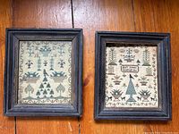 Two framed samplers side by side showing full lot