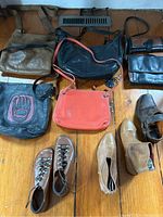 Overview of all included purses and shoes arranged on wooden floor showing condition and style.